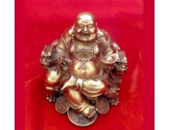brass laughing buddha sitting on a dragon chair